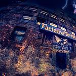 Factory of Terror Haunted House exterior with spooky lighting and gargoyle