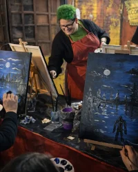 Instructor helping guests paint nighttime scenes during Paint Night at Factory of Terror in Fall River MA