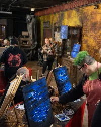 Guests painting canvases during a Paint Night event inside Factory of Terror in Fall River Massachusetts